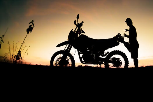 Men's silhouettes and touring motocross bikes. Park to relax in the mountains in the evening. adventure travel and leisure concept photo