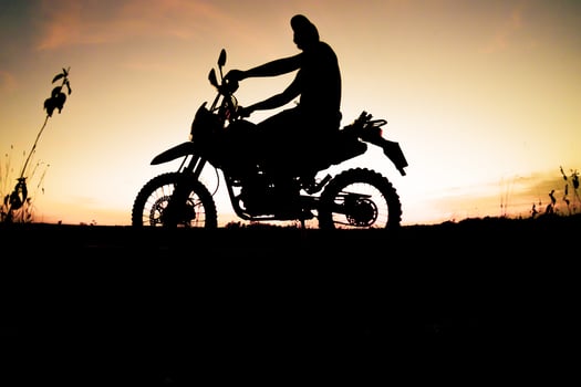 Men's silhouettes and touring motocross bikes. Park to relax in the mountains in the evening. adventure travel and leisure concept photo