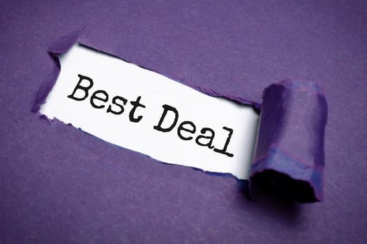 best deal word on paper over torn paper background. photo