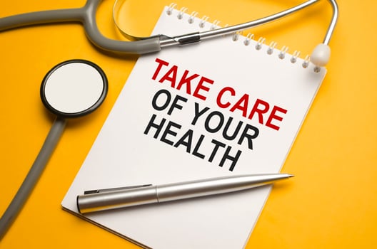 stethoscope, a pen and a notepad with the inscription Take care of your health photo