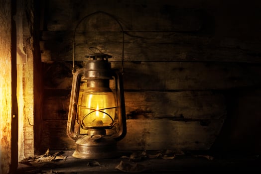 Antique lantern kerosene on an old overgrown wood photo