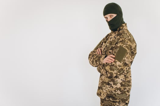 Portrait of a Ukrainian soldier in military uniform on a white background photo