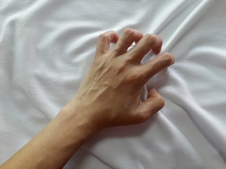 Girl's hand on a white silk background photo