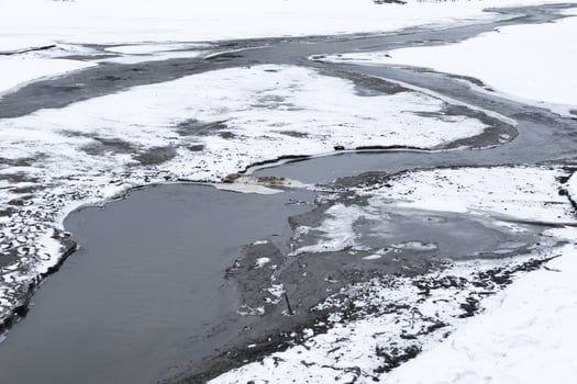 Frozen river, thawed places, beautiful landscape photo