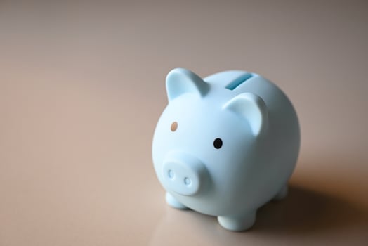 Piggy bank on floor background, blue piggy bank saving money for education study or investment concept photo