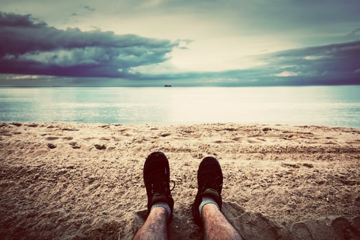 First person perspective of man legs on the autumn beach. Vintage photo
