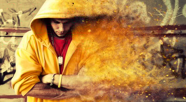 Young man in hooded sweatshirt on grunge wall photo