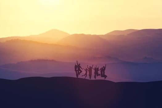 Group of people jumping high on the hill photo
