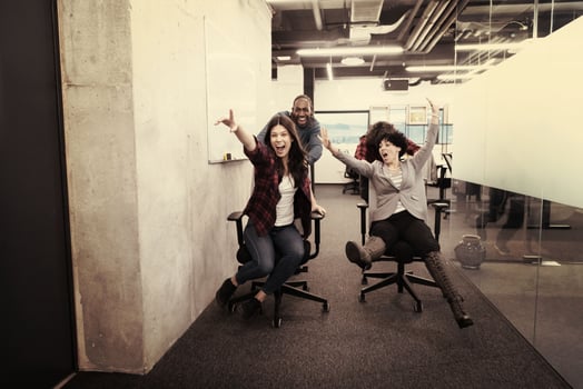 multiethnics business team racing on office chairs photo