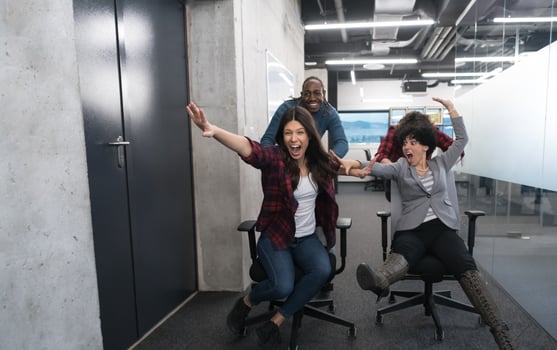 multiethnics business team racing on office chairs photo