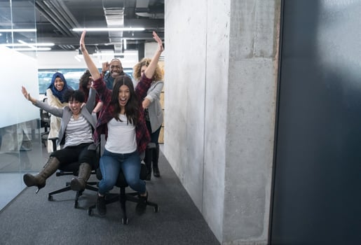 multiethnics business team racing on office chairs photo