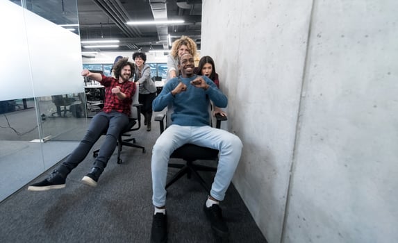 multiethnics business team racing on office chairs photo