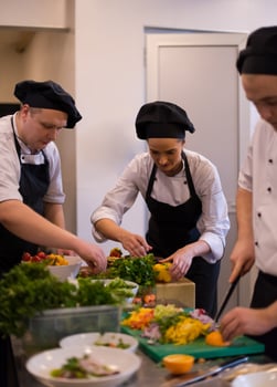 team cooks and chefs preparing meal photo
