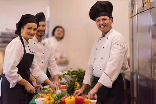team cooks and chefs preparing meal photo