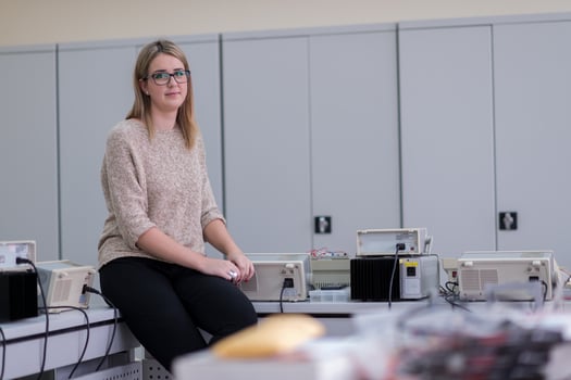 female student sitting on the table photo
