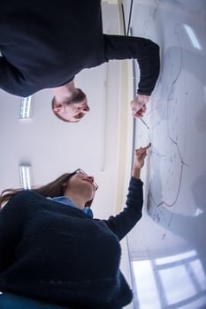 students writing on the white chalkboard photo