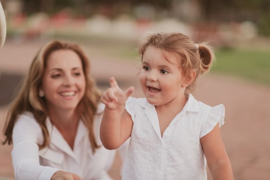 An elderly woman in casual clothes with his daughter spends time together in the park on vacation. Family time. Selective focus photo