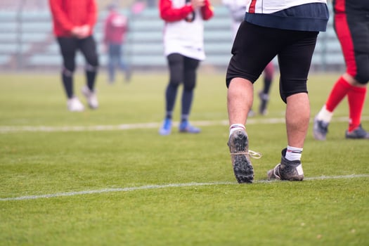 close up of american football players stretching and warming up photo