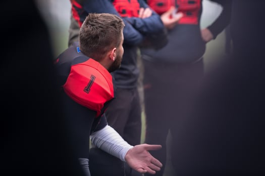 american football player discussing strategy with his team photo