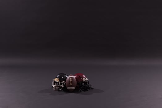 american football and helmets isolated on gray photo