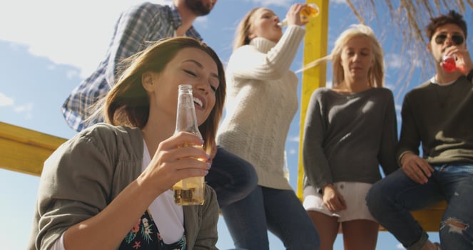 Group of friends having fun on autumn day at beach photo