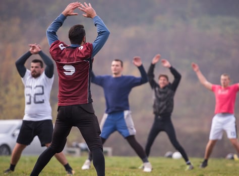 american football players stretching and warming up photo