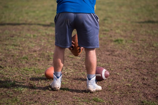 american football kicker practicing kickoff photo