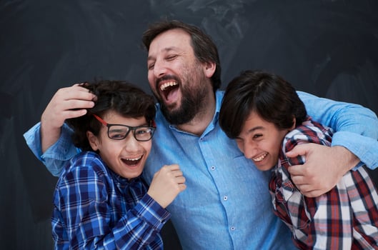 happy father hugging sons photo