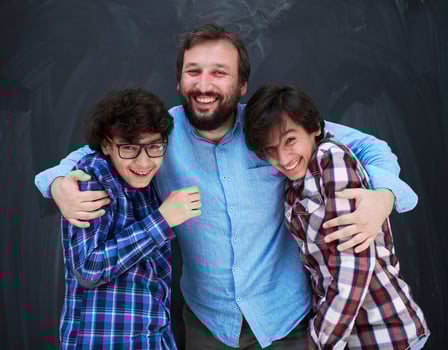 happy father hugging sons photo