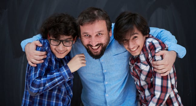 happy father hugging sons photo