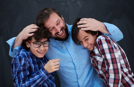 happy father hugging sons photo