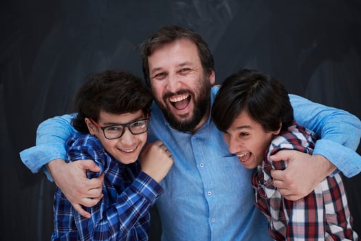 happy father hugging sons photo