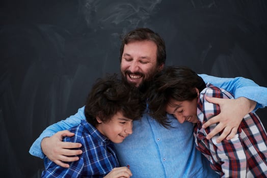 happy father hugging sons photo