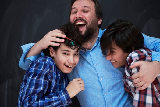 happy father hugging sons photo