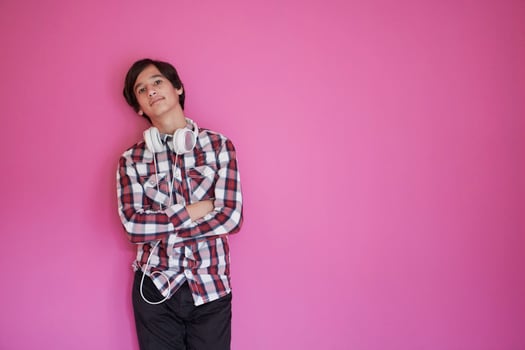 portrait  of smart looking arab teenager  against pink background photo