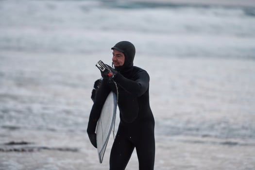 Arctic surfer going by beach after surfing photo