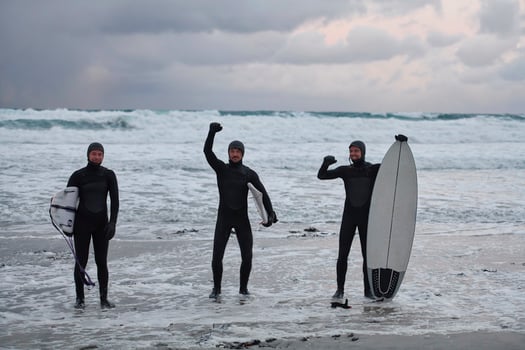 Arctic surfers going by beach after surfing photo
