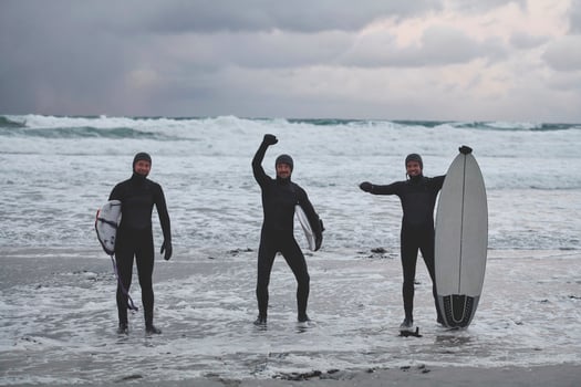Arctic surfers going by beach after surfing photo