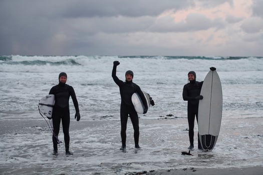 Arctic surfers going by beach after surfing photo