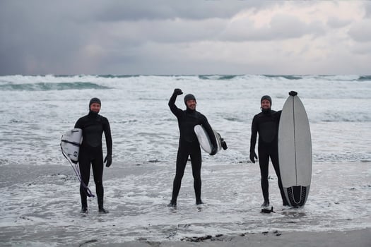 Arctic surfers going by beach after surfing photo