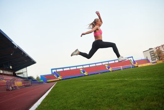 Athletic woman running on track photo