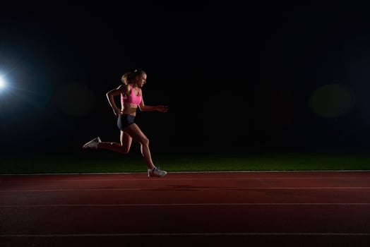 Athletic woman running on track photo