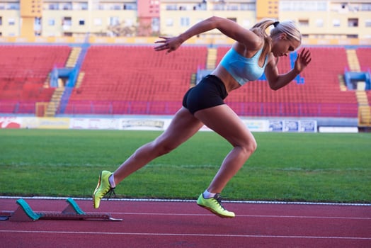 pixelated design of woman  sprinter leaving starting blocks photo