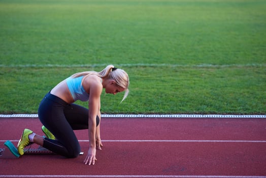 pixelated design of woman  sprinter leaving starting blocks photo
