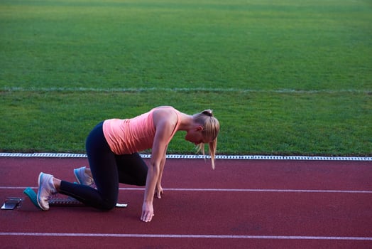 pixelated design of woman  sprinter leaving starting blocks photo