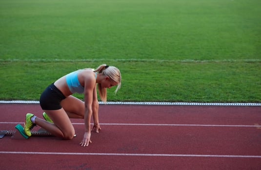 athlete woman group  running on athletics race track photo
