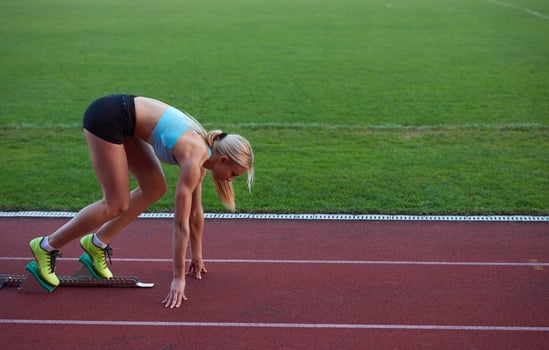 athlete woman group  running on athletics race track photo