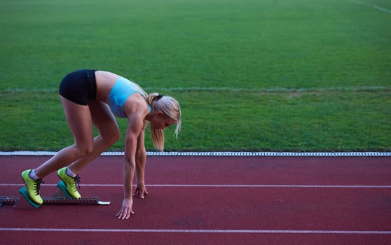 pixelated design of woman  sprinter leaving starting blocks photo