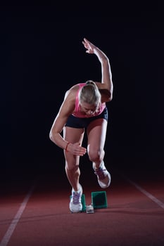 pixelated design of woman  sprinter leaving starting blocks photo