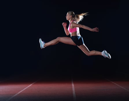 Athletic woman running on track photo